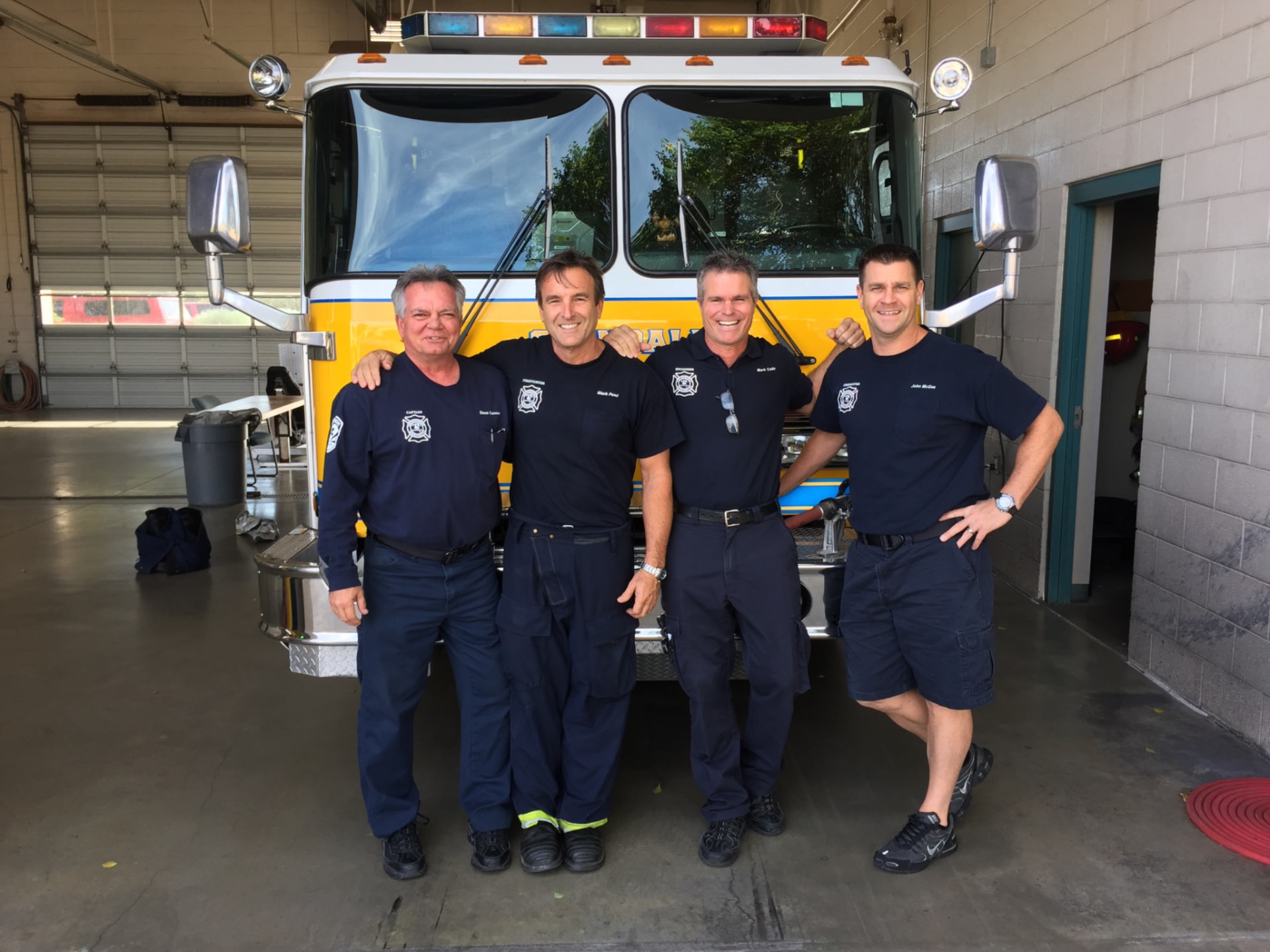 Glendale firefighters standing in front of an engine at the station